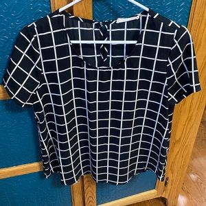 Short sleeve, light weight blouse. Black and cream check.